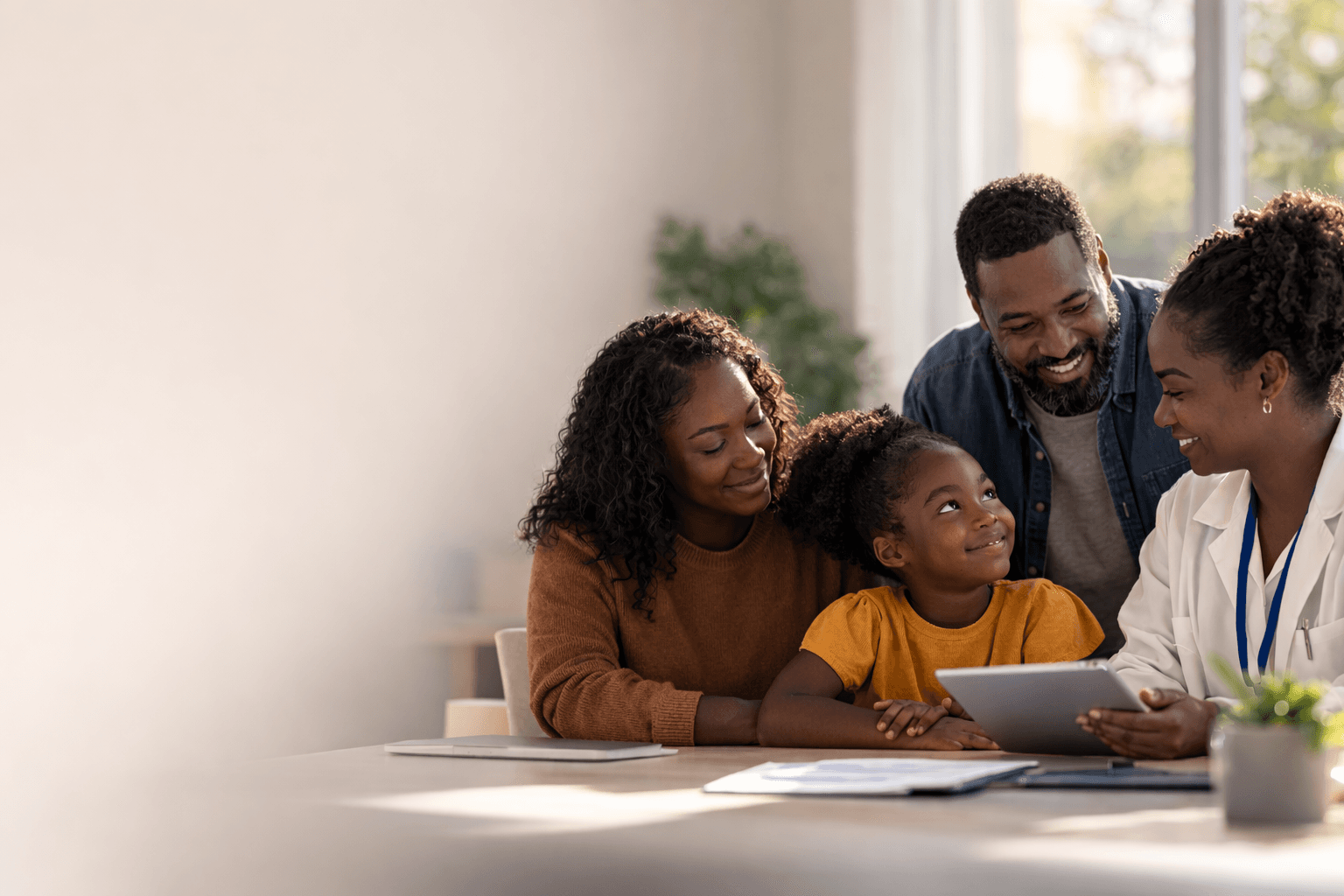 African American family with doctor reviewing health information